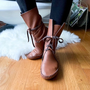 handmade moccasins | indigenous maker | tall boot | hi-top moccasins | moccasin boots | wrap up laces | cinnamon | barefoot shoes | leather