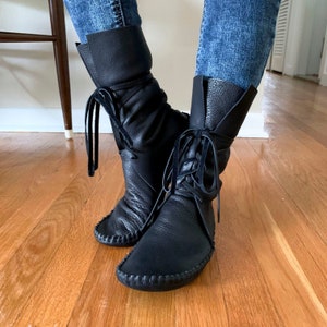 handmade moccasins | indigenous maker | tall boot | hi-top moccasins | moccasin boots | wrap up laces | black leather | custom | barefoot