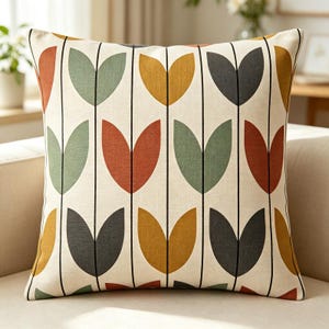 May include: A square throw pillow with an off-white base featuring a repeating vertical pattern of thin black lines and stylized tulip-like shapes in muted shades of mustard yellow, sage green, charcoal gray, and burnt orange throughout the fabric.