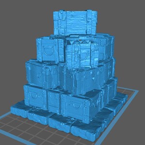 May include: A stack of blue vintage-style trunks, arranged in a pyramid shape. Each trunk features a handle, metal accents, and a rectangular form. The trunks are stacked on a base of similar blue blocks, creating a tiered structure.