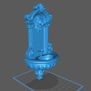 May include: A blue decorative wall fountain with ornate detailing. The fountain features a lion's head, a small basin, and a decorative base. The design is reminiscent of classical architecture.