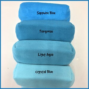 May include: Four fabric swatches in shades of blue, from lightest to darkest: Crystal Blue, Light Aqua, Turquoise, and Sapphire Blue.