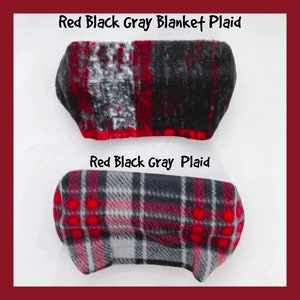 May include: Two red, black, and gray plaid fleece blankets. The top blanket has a more abstract pattern, while the bottom blanket has a more traditional plaid pattern.