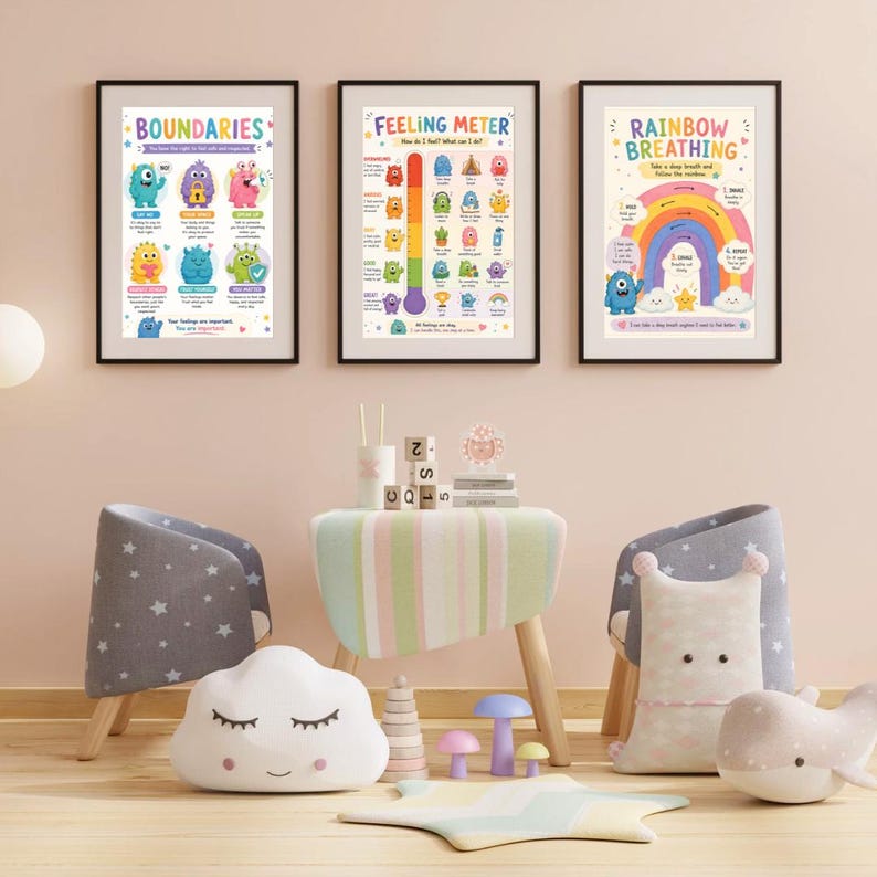 May include: Three framed posters with colourful illustrations and text, including "BOUNDARIES," "FEELING METER," and "RAINBOW BREATHING." The room features a small table, two chairs, and decorative pillows shaped like a cloud, a star, and a whale.