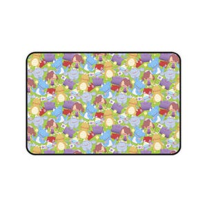 May include: Rectangular mousepad featuring a repeating pattern of cartoon characters in various colors. The characters are primarily blue, yellow, purple, and brown, set against a light green background. The mousepad has a black border.