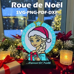 May include: A Christmas-themed advent calendar featuring a cartoon character wearing a Santa hat. The design includes a circular dial with numbers, the text "Roue de Noël", and "Joyeux Noël". The image is set against a festive background with candles and decorations.