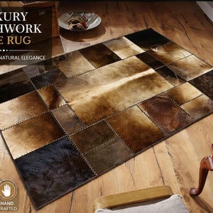 May include: A patchwork hide rug with a variety of brown and tan tones. The rug is made of squares of natural hide, stitched together. The text "LUXURY PATCHWORK HIDE RUG" is displayed at the top of the image.