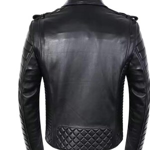 May include: Black leather jacket with quilted shoulder and lower back panel detailing. The jacket features a classic biker style with a notched collar, asymmetrical zipper, and multiple pockets. The back view showcases the jacket's tailored fit and sleek design.