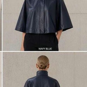 May include: Navy blue leather cape jacket with a high collar and button closure. The jacket has a cropped length and short sleeves. The text "NAVY BLUE" is visible in the image.
