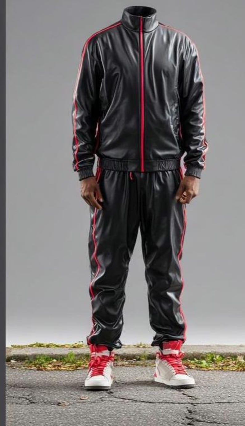 May include: Black tracksuit with red accents. The jacket has a high collar and a red zipper. Red stripes run down the sides of the jacket and pants. The matching pants have a drawstring waist. The outfit is completed with red and white sneakers.