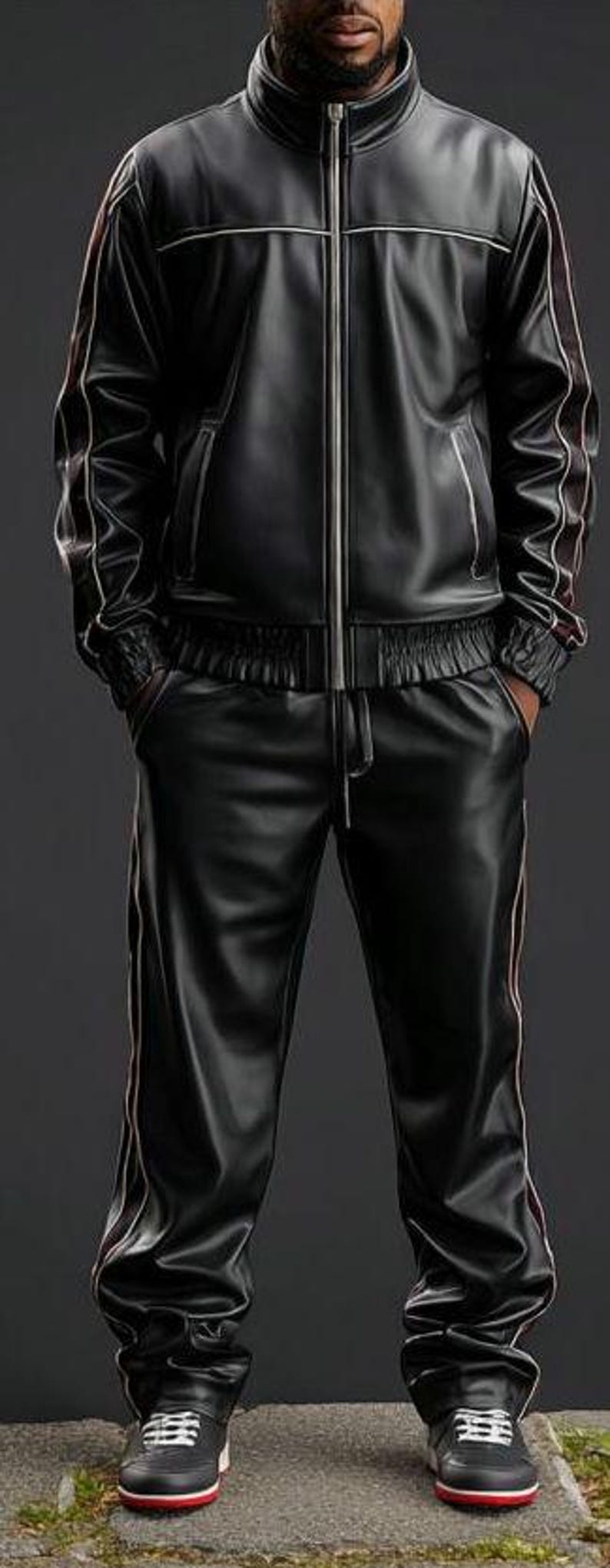 May include: Black leather tracksuit with white and red accents. The jacket has a zip-up front and the pants have a drawstring waist. The outfit is paired with black sneakers with red soles.