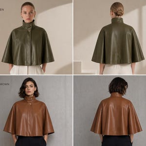 May include: Two leather capes in olive green and caramel brown. Each cape features a high collar and button closure. The olive green cape is styled with white pants, while the caramel brown cape is paired with black pants.