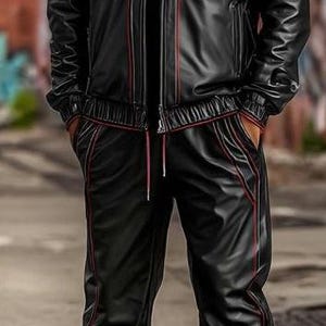May include: Black tracksuit with red trim. The jacket has a hood and a zipper closure. The pants have a drawstring waist. The outfit is worn with white and silver sneakers. The tracksuit is made of a shiny material.
