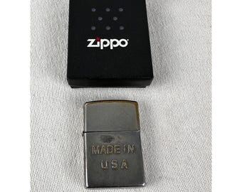 Vintage Zippo lighter Made in USA on front.