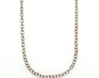 May include: A silver-toned metal chain necklace featuring a series of uniform, circular interlocking links. The chain is displayed in a simple U-shape, showcasing the consistent texture and metallic finish of the individual round links throughout.