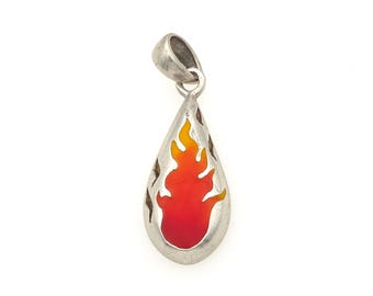 May include: A silver-toned teardrop-shaped pendant featuring a central flame design with a gradient of red to yellow enamel. The metal frame has a smooth, polished finish and includes a small integrated bail at the top for attachment to a chain.