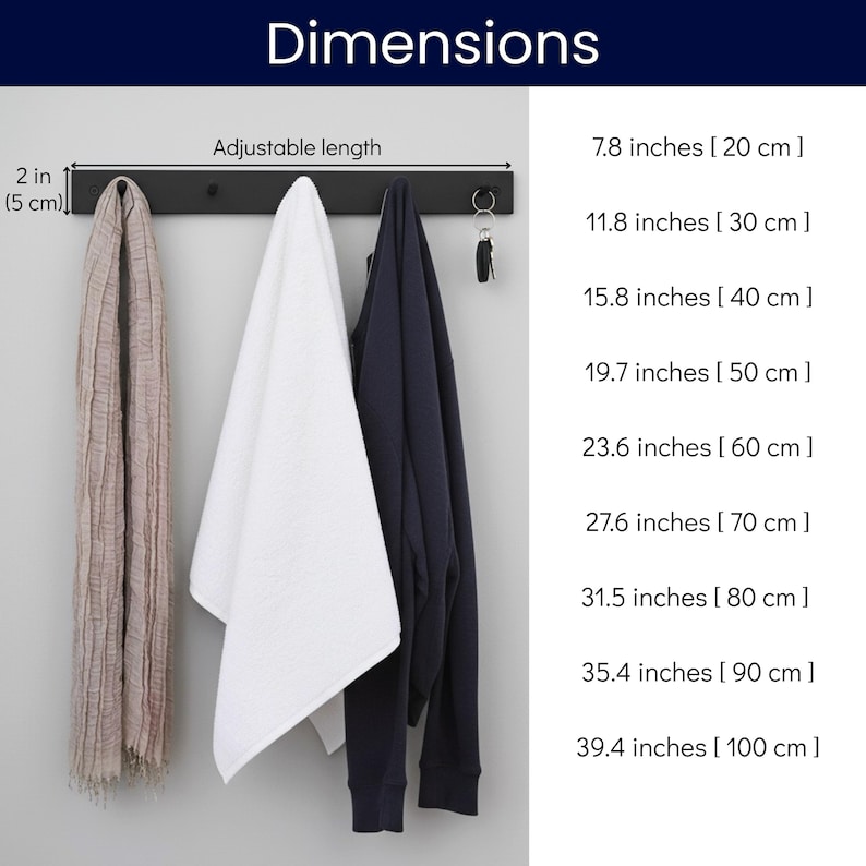 May include: A black metal wall-mounted coat rack with three items hanging from it: a beige scarf, a white towel, and a navy blue sweatshirt. The dimensions are listed in inches and centimeters.