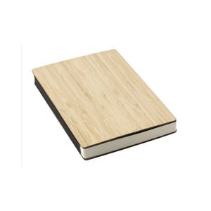 May include: A rectangular notebook with a light brown bamboo cover. The cover has a natural wood grain pattern. The edges of the notebook are black, and the pages are white. The notebook is set against a white background.