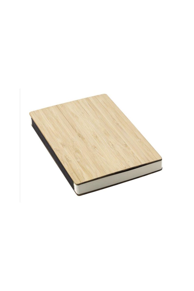 May include: A rectangular notebook with a light brown bamboo cover. The cover has a natural wood grain pattern. The edges of the notebook are black, and the pages are white. The notebook is set against a white background.