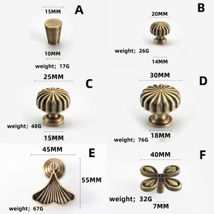 May include: A selection of antique brass cabinet hardware, including knobs and a pull. The knobs vary in size and design, with measurements in millimetres and weights in grams. Suitable for furniture restoration projects.
