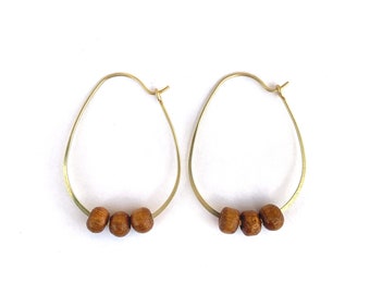 Gold brass oval hoops with natural wooden beads