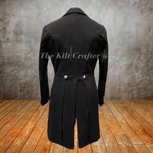 Close-up of velvet lapels and ornate metal buttons on men’s black Victorian tailcoat, gothic vintage tuxedo style