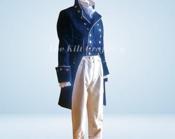 May include: A navy blue military-style coat with white trim and gold buttons, paired with cream-colored trousers. The coat features a high collar and long sleeves with buttoned cuffs. The outfit is displayed on a mannequin.