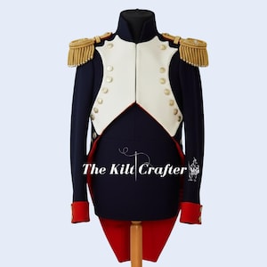 May include: A navy blue military jacket with a white vest, gold epaulets, and red accents. The jacket has gold buttons and red cuffs. The Kilt Crafter is printed on the jacket.