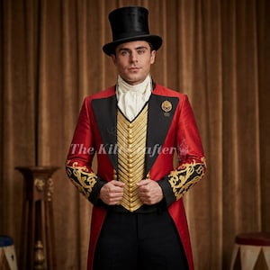 May include: A red tailcoat with black lapels and gold embroidery on the cuffs, worn with a white cravat and a gold-buttoned vest. A black top hat sits atop the head. The text The Kiltcrafter is visible across the center of the red jacket.