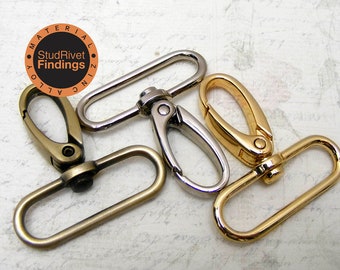 May include: An assortment of metal swivel clasps in various finishes: antique brass, silver, and gold. The clasps are oval-shaped with a spring-loaded gate for secure attachment. The image includes the text "StudRivet Findings".
