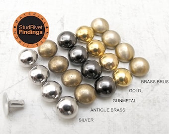 May include: Assortment of round metal studs in various finishes, including silver, antique brass, gunmetal, gold, and brass brush. The studs are arranged in rows by color. The image also includes a close-up of a single stud with a post.
