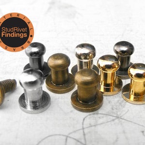 May include: Assortment of metal studs and rivets in silver, brass, and gold finishes. The studs have a round top and a flat base. The rivets have a round top and a cylindrical base. The studs and rivets are used for attaching fabric, leather, or other materials.