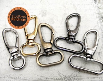 May include: Four swivel snap hooks in different finishes: gold, antique brass, nickel, and gunmetal. The hooks are made of zinc alloy and are suitable for attaching to bags, purses, or other accessories.