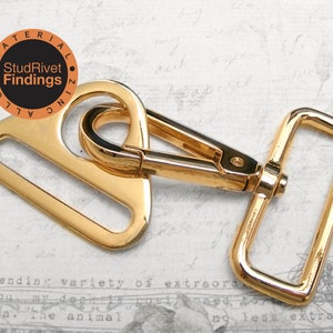 May include: Gold-toned metal swivel hook with a rectangular loop. The hook is attached to a D-ring. The hook is made of zinc alloy.