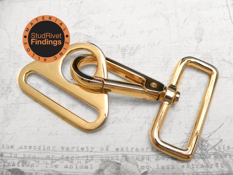 May include: Gold-toned metal swivel hook with a rectangular loop. The hook is attached to a D-ring. The hook is made of zinc alloy.