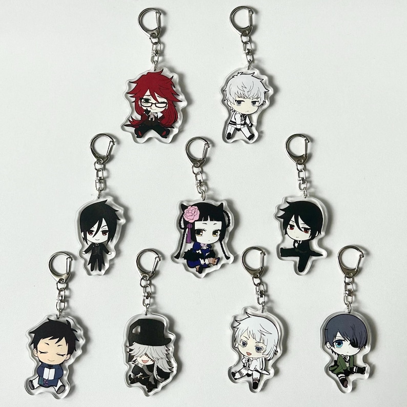 May include: Set of ten anime character keychains featuring characters from the Black Butler series. The keychains are made of clear acrylic and feature colorful illustrations of the characters.