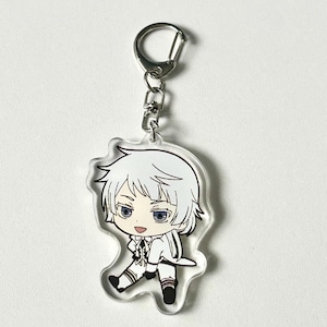 May include: A white and silver anime character keychain with a silver chain. The character has white hair, blue eyes, and is wearing a white suit.