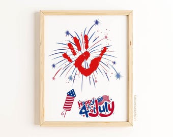 May include: Framed print with a red handprint and fireworks design in red, white, and blue. The text "Happy 4th of July" is displayed below a rocket graphic. The artwork is in a wooden frame.