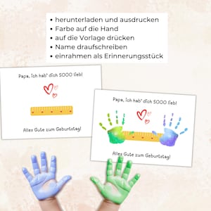 May include: Two white cards with the text "Papa, ich hab' dich SOOO lieb!" and "Alles Gute zum Geburtstag!" are displayed. One card has a ruler graphic and the other has handprints. The image also shows blue and green handprints.
