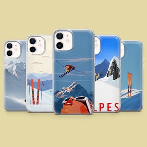 May include: Five different phone cases featuring winter mountain scenes. The cases depict skiers, mountains, and the word "ALPES".