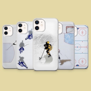 May include: A collection of five clear phone cases featuring hockey-themed designs. The cases showcase images of hockey players in action, ice rink details, and hockey game diagrams. The cases are designed to fit a smartphone.