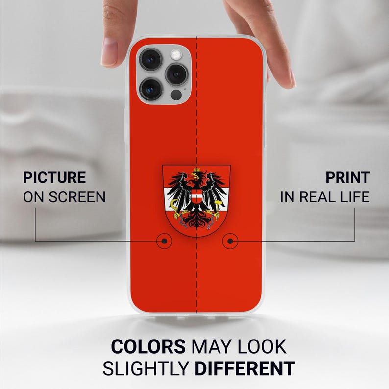 Peut inclure: Une coque de t&eacute;l&eacute;phone rouge pour iPhone avec un blason autrichien blanc et noir. La coque a un dos transparent et une bordure blanche. Le texte "IMPRIMER EN VRAI" est visible sur le c&ocirc;t&eacute; droit de l'image.