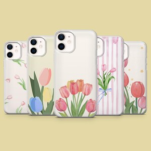 May include: Five clear phone cases with floral designs. The cases feature watercolor illustrations of tulips in various colors, including pink, yellow, and red, with green leaves. One case has a pink and white striped pattern.