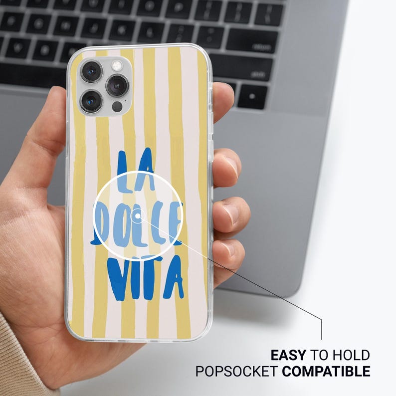 May include: A clear phone case with a yellow and white striped background and blue text that says "La Dolce Vita".