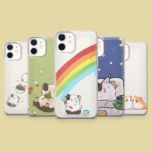 May include: Five different phone cases featuring cute cartoon guinea pigs. The cases are clear and show a variety of designs, including a rainbow, a sleeping guinea pig, and a guinea pig painting.