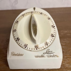 May include: A set of three ceramic mugs with a speckled, matte finish. Each mug features a different color: light blue, cream, and gray. The mugs have a simple, modern design and a comfortable handle.