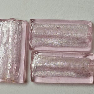Lampwork glass beads.  Pale pink, foil lined rectangles.  Sold in pairs