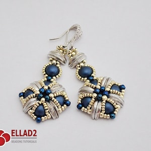 May include: A pair of handcrafted dangle earrings. The earrings feature a silver-tone metal design with gold accents and dark blue beads. The earrings have a floral-like shape and are suspended from silver-tone ear wires.