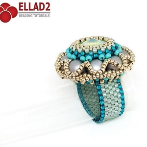May include: A turquoise and silver beaded ring with a large, iridescent green gemstone in the center. The ring is made with seed beads and pearls.