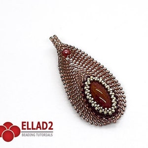 May include: A teardrop-shaped pendant with a red gemstone set in a beaded frame. The pendant is made with brown and silver beads and has a delicate, intricate design.